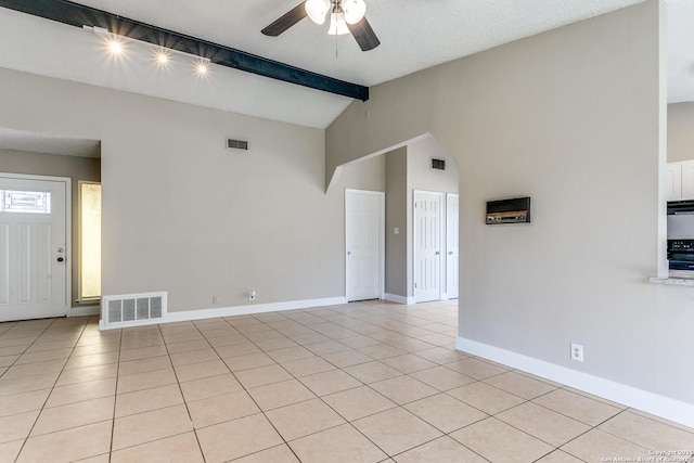 interior space featuring light tile patterned floors, baseboards, visible vents, and beamed ceiling