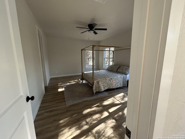 bedroom featuring a ceiling fan, baseboards, and wood finished floors