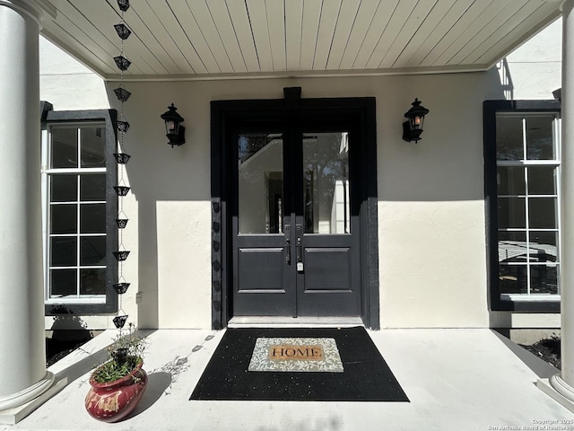 property entrance with french doors and stucco siding