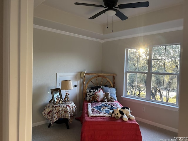 bedroom featuring crown molding, carpet flooring, a raised ceiling, and baseboards