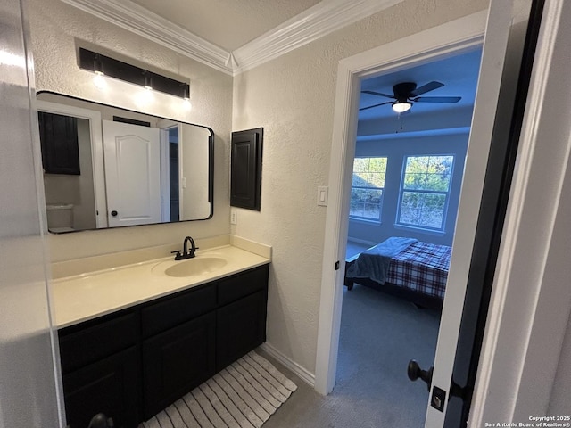 bathroom featuring ornamental molding, a textured wall, vanity, and ceiling fan