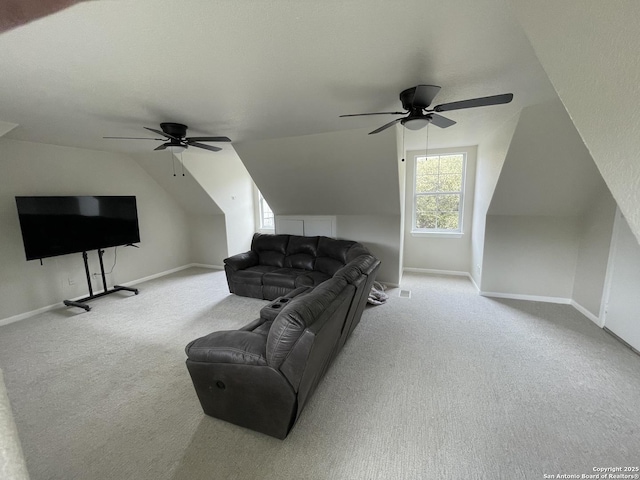 living room with vaulted ceiling, carpet floors, and baseboards