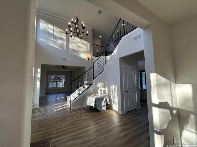 interior space with stairway, wood finished floors, and visible vents