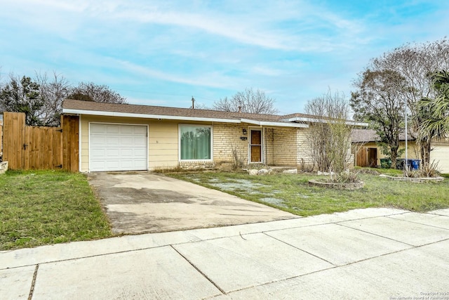 ranch-style house with brick siding, concrete driveway, fence, a garage, and a front lawn