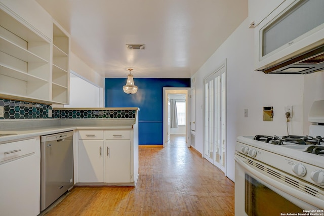 kitchen featuring range hood, gas range gas stove, open shelves, white cabinetry, and dishwasher