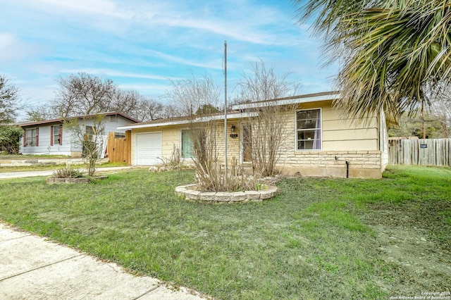 ranch-style house featuring a garage, a front yard, stone siding, and fence