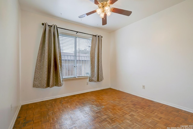 unfurnished room featuring baseboards and a ceiling fan