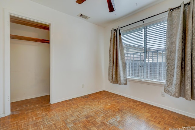 unfurnished bedroom featuring a ceiling fan, a closet, visible vents, and baseboards