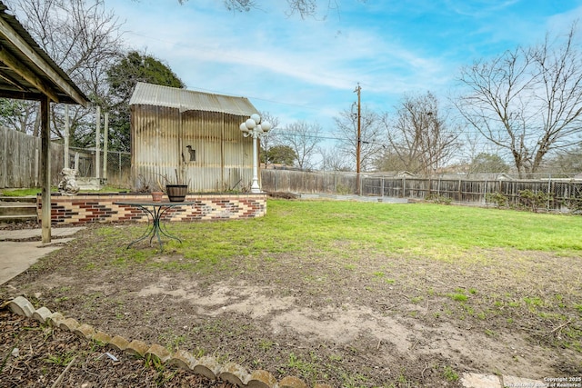 view of yard featuring an outbuilding and a fenced backyard