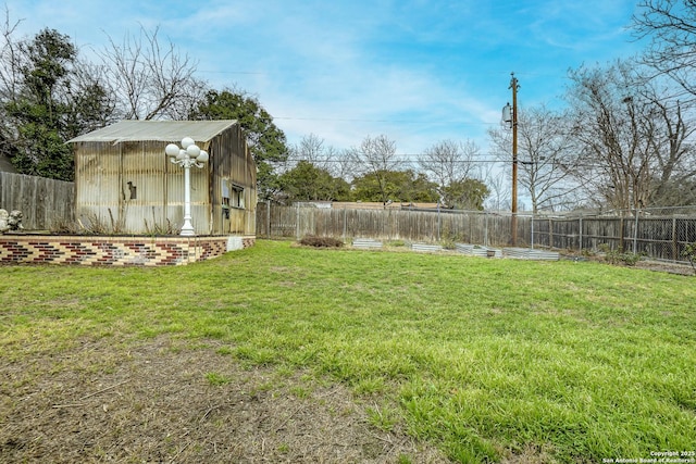 view of yard with an outbuilding and a fenced backyard