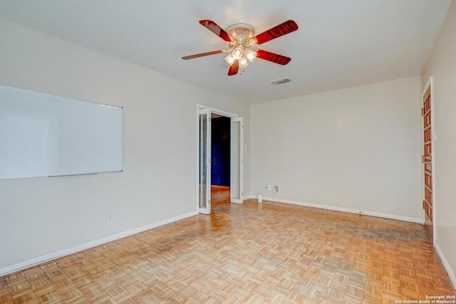 empty room featuring visible vents, ceiling fan, and baseboards