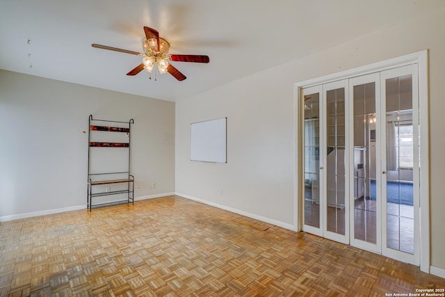 unfurnished room featuring baseboards and a ceiling fan