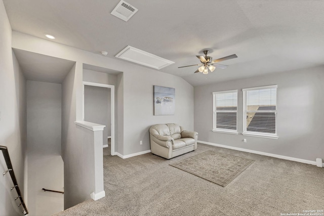 unfurnished room featuring visible vents, baseboards, lofted ceiling, carpet, and an upstairs landing