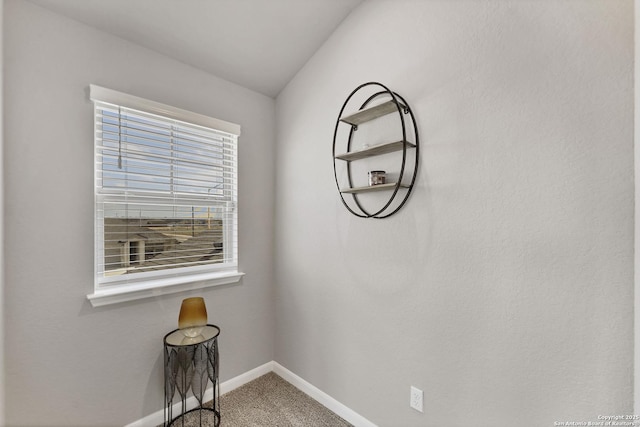 carpeted empty room featuring baseboards