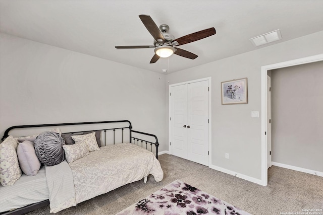 carpeted bedroom with a closet, visible vents, ceiling fan, and baseboards