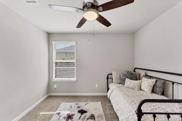 carpeted bedroom with ceiling fan, visible vents, and baseboards