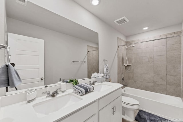 bathroom featuring visible vents, a sink, and toilet