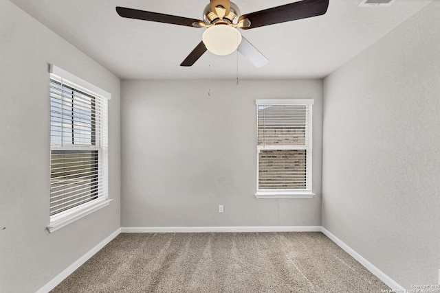 carpeted spare room featuring visible vents and baseboards