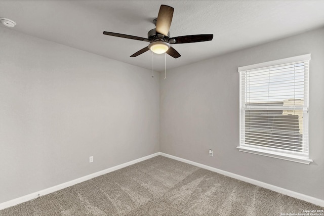 unfurnished room featuring carpet floors, baseboards, and a ceiling fan