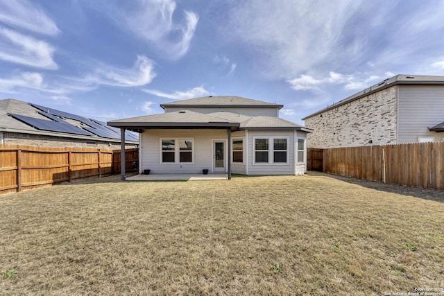 back of property featuring a yard, a patio area, and a fenced backyard