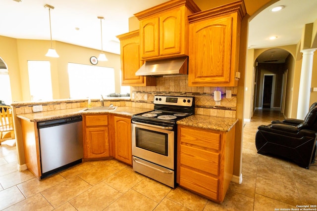 kitchen with arched walkways, stainless steel appliances, a sink, ventilation hood, and decorative backsplash