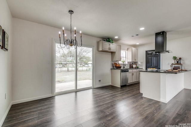 kitchen featuring dark wood-style flooring, dishwasher, dark countertops, exhaust hood, and a chandelier