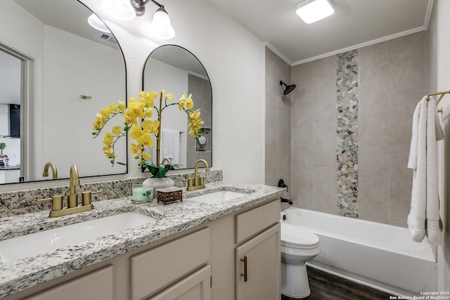 full bathroom with  shower combination, toilet, wood finished floors, and a sink