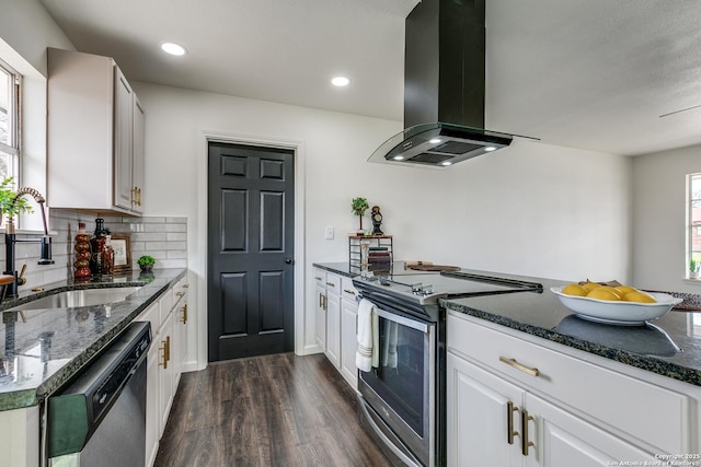 kitchen featuring dark wood-style flooring, a sink, decorative backsplash, appliances with stainless steel finishes, and island range hood