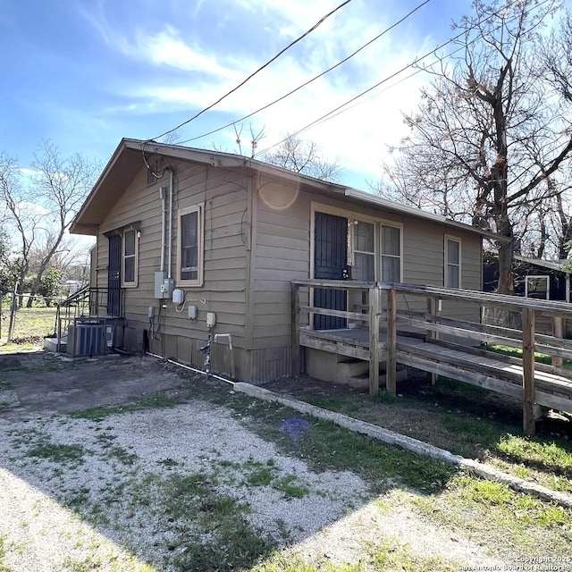 view of front facade featuring a deck and cooling unit