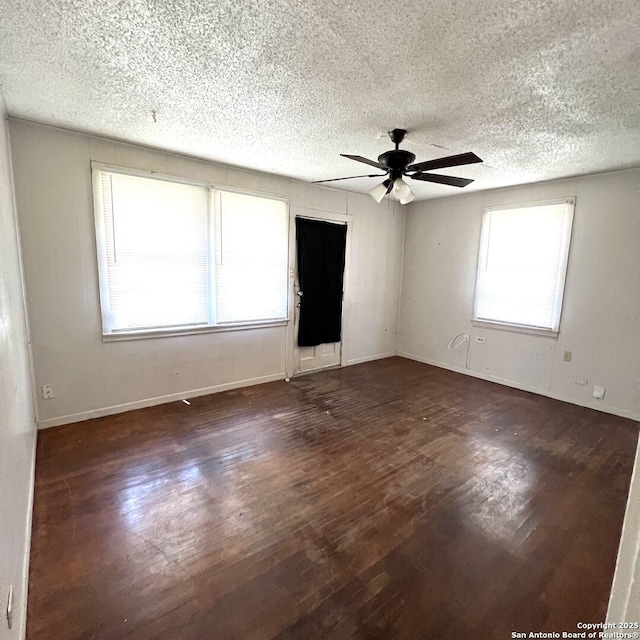 spare room featuring baseboards, a textured ceiling, a ceiling fan, and wood finished floors