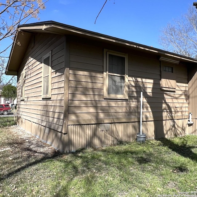 view of property exterior with a lawn