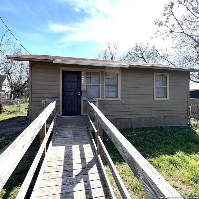 exterior space featuring fence and a front lawn