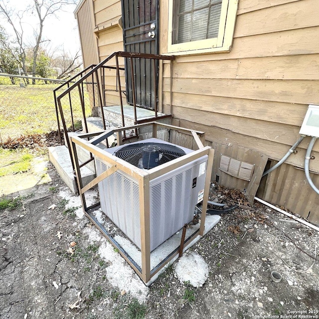 exterior details with fence and central air condition unit