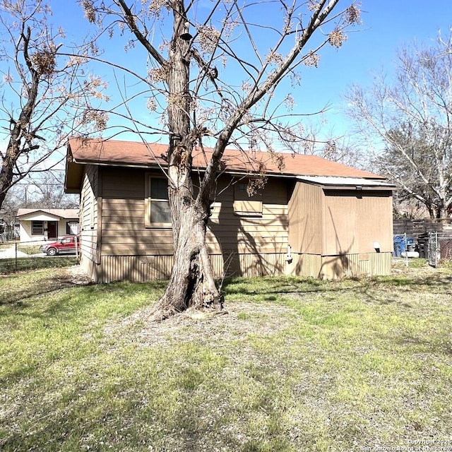 exterior space featuring fence and a yard