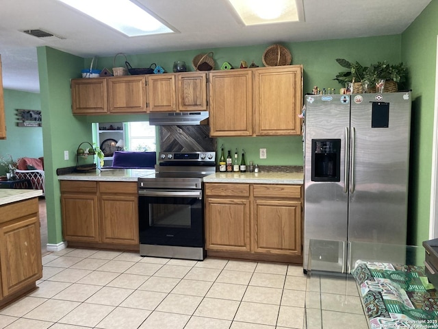 kitchen featuring under cabinet range hood, visible vents, appliances with stainless steel finishes, and light countertops