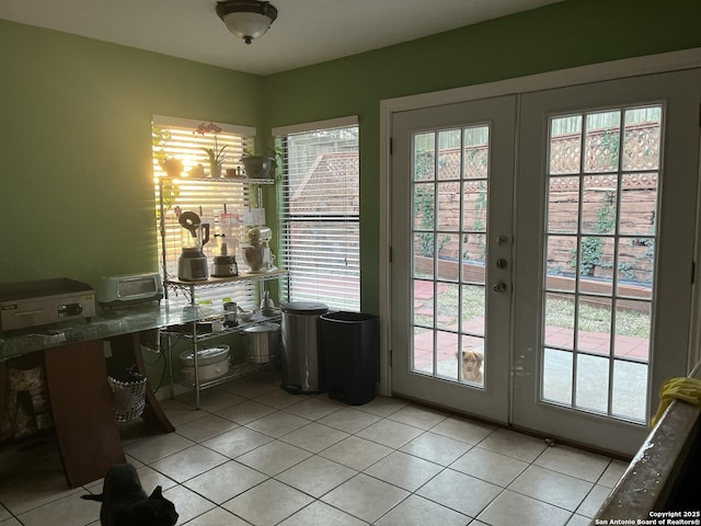 entryway with light tile patterned floors and french doors