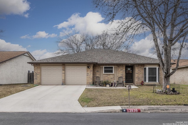 ranch-style home featuring an attached garage, brick siding, driveway, roof with shingles, and a front yard