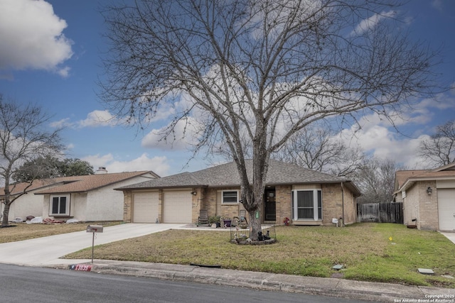 ranch-style home featuring a garage, brick siding, fence, driveway, and a front yard