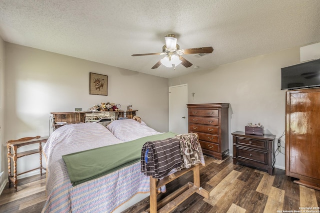 bedroom with dark wood-style floors, ceiling fan, a textured ceiling, and baseboards