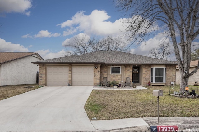 single story home featuring brick siding, a shingled roof, concrete driveway, an attached garage, and a front yard