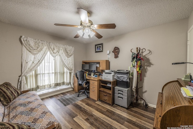 office featuring dark wood-style floors, a textured ceiling, baseboards, and a ceiling fan