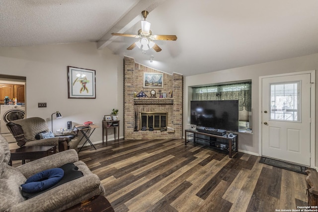 living area featuring a fireplace, washer / clothes dryer, lofted ceiling with beams, wood finished floors, and baseboards