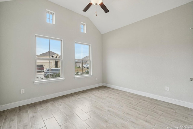 empty room featuring light wood-type flooring, ceiling fan, baseboards, and vaulted ceiling