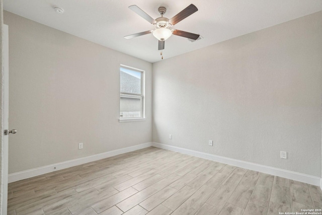 empty room with light wood finished floors, ceiling fan, and baseboards