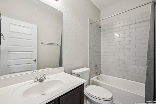 bathroom with toilet, a textured wall, shower / bath combo, and vanity