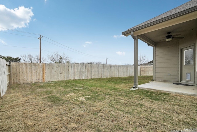 view of yard with a patio area, a fenced backyard, and a ceiling fan