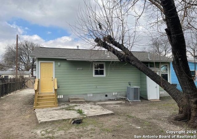 back of property with entry steps, central AC, crawl space, and fence