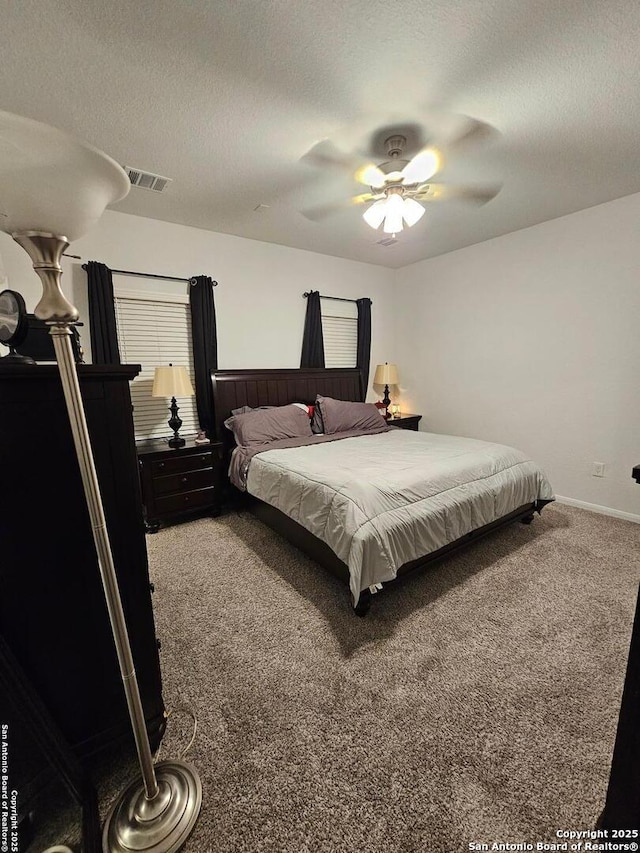 106 Tokalaun Dr, Hutto, TX 78634 - carpeted bedroom featuring a textured ceiling, visible vents, and a ceiling fan