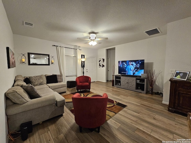 106 Tokalaun Dr, Hutto, TX 78634 - living room featuring visible vents, ceiling fan, a textured ceiling, and wood finished floors