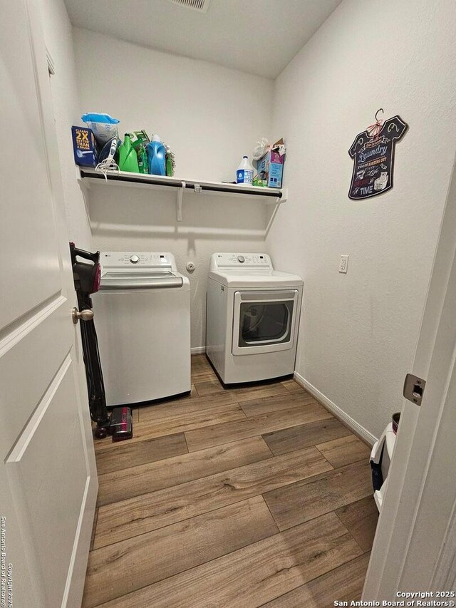 106 Tokalaun Dr, Hutto, TX 78634 - clothes washing area with laundry area, baseboards, separate washer and dryer, and wood finished floors